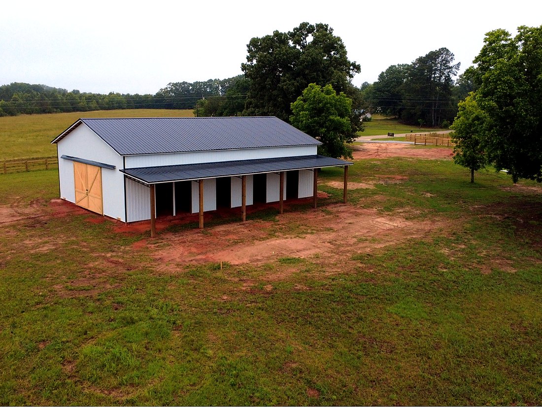 Three-quarter view of the horse barn showing full footprint and stall lean-to