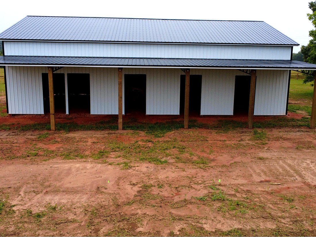 Side view of five open horse stall bays