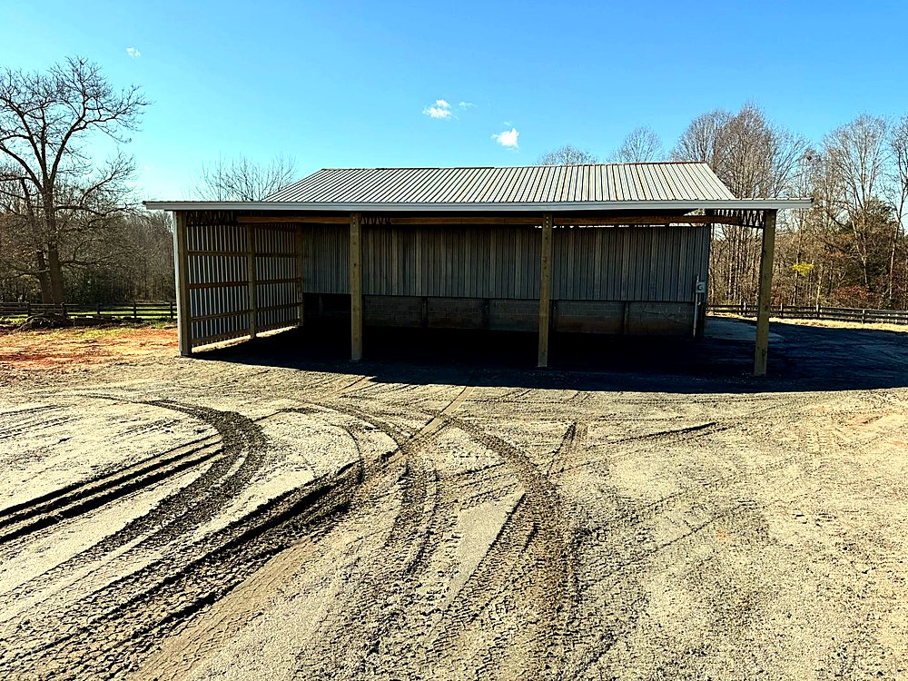 Three-sided metal utility barn on a concrete block foundation